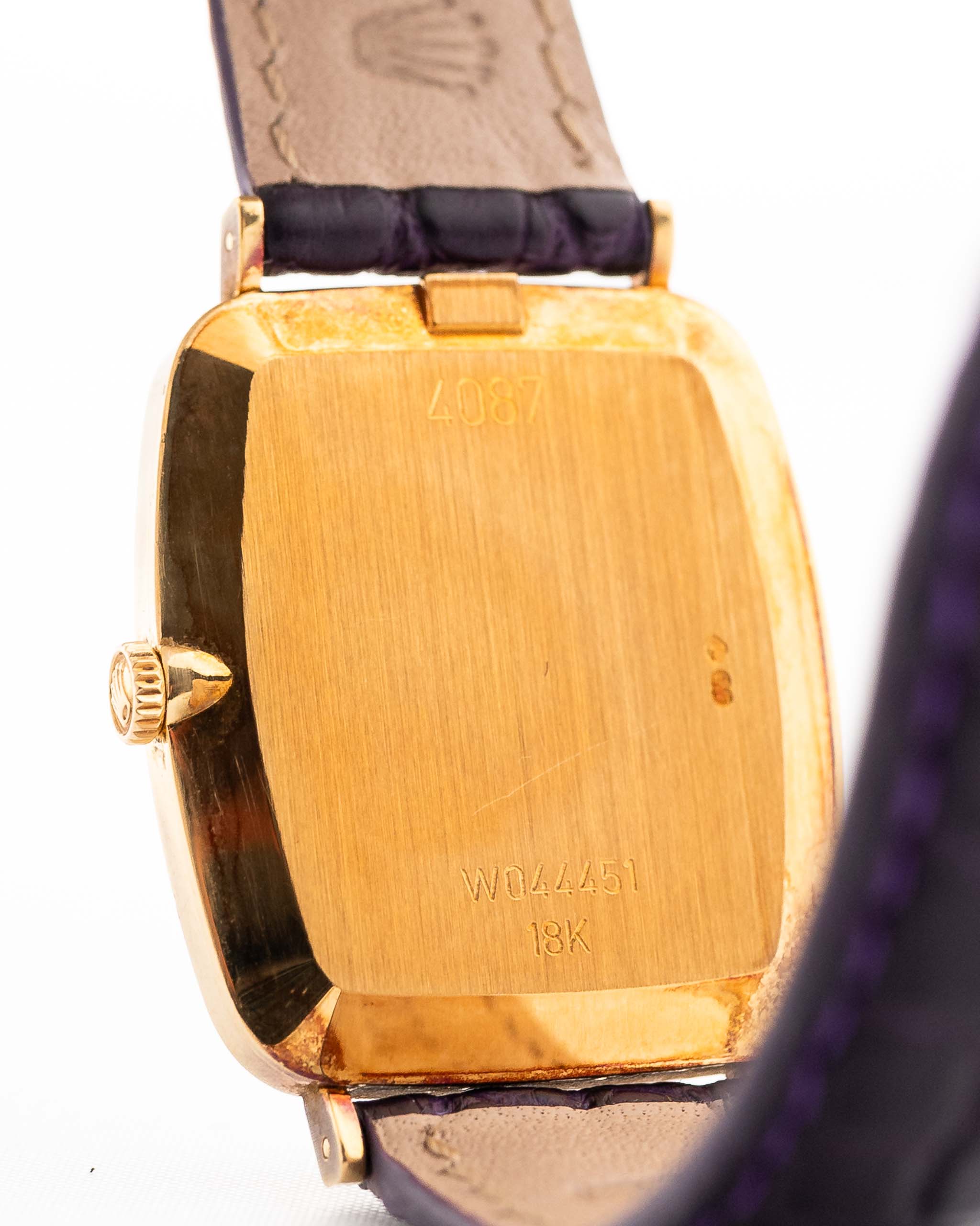 Closeup Photo of a Rolex Cellini 4087 Rectangular from 1995. 27.5mm in 18k Yellow Gold with Manual Wind Movement, Silver Sunburst Dial and Original Leather Strap.