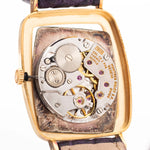 Closeup Photo of a Rolex Cellini 4087 Rectangular Movement from 1995. 27.5mm in 18k Yellow Gold with Manual Wind Movement, Silver Sunburst Dial and Original Leather Strap.