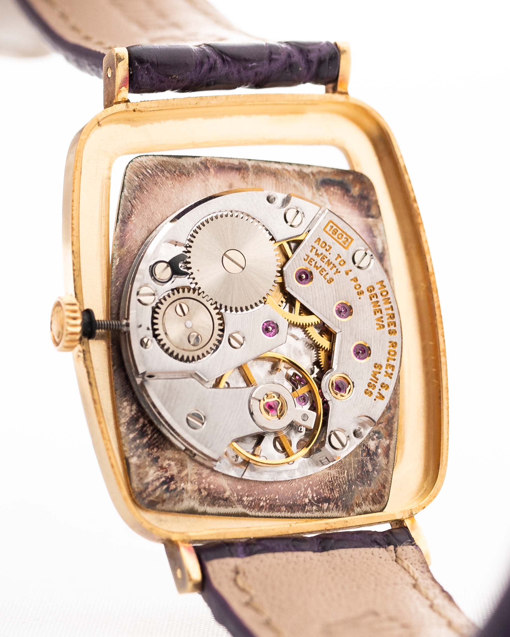 Closeup Photo of a Rolex Cellini 4087 Rectangular Movement from 1995. 27.5mm in 18k Yellow Gold with Manual Wind Movement, Silver Sunburst Dial and Original Leather Strap.