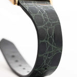 Closeup Photo of a Rolex Cellini 4105 Rectangular Black from 1976. 25.5mm  18k yellow gold case with Manual wind movement, Original black tapestry dial and Leather strap.