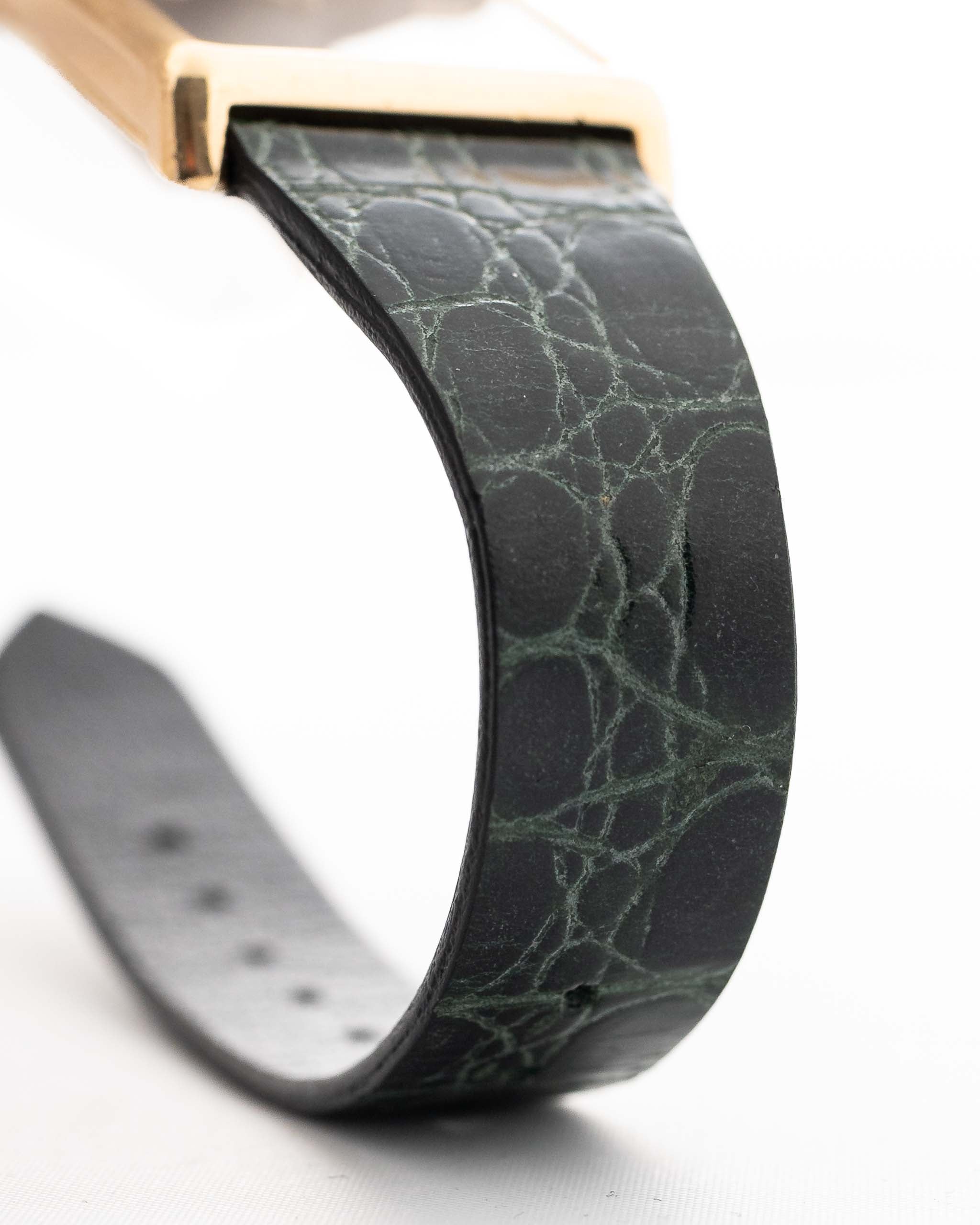 Closeup Photo of a Rolex Cellini 4105 Rectangular Black from 1976. 25.5mm  18k yellow gold case with Manual wind movement, Original black tapestry dial and Leather strap.