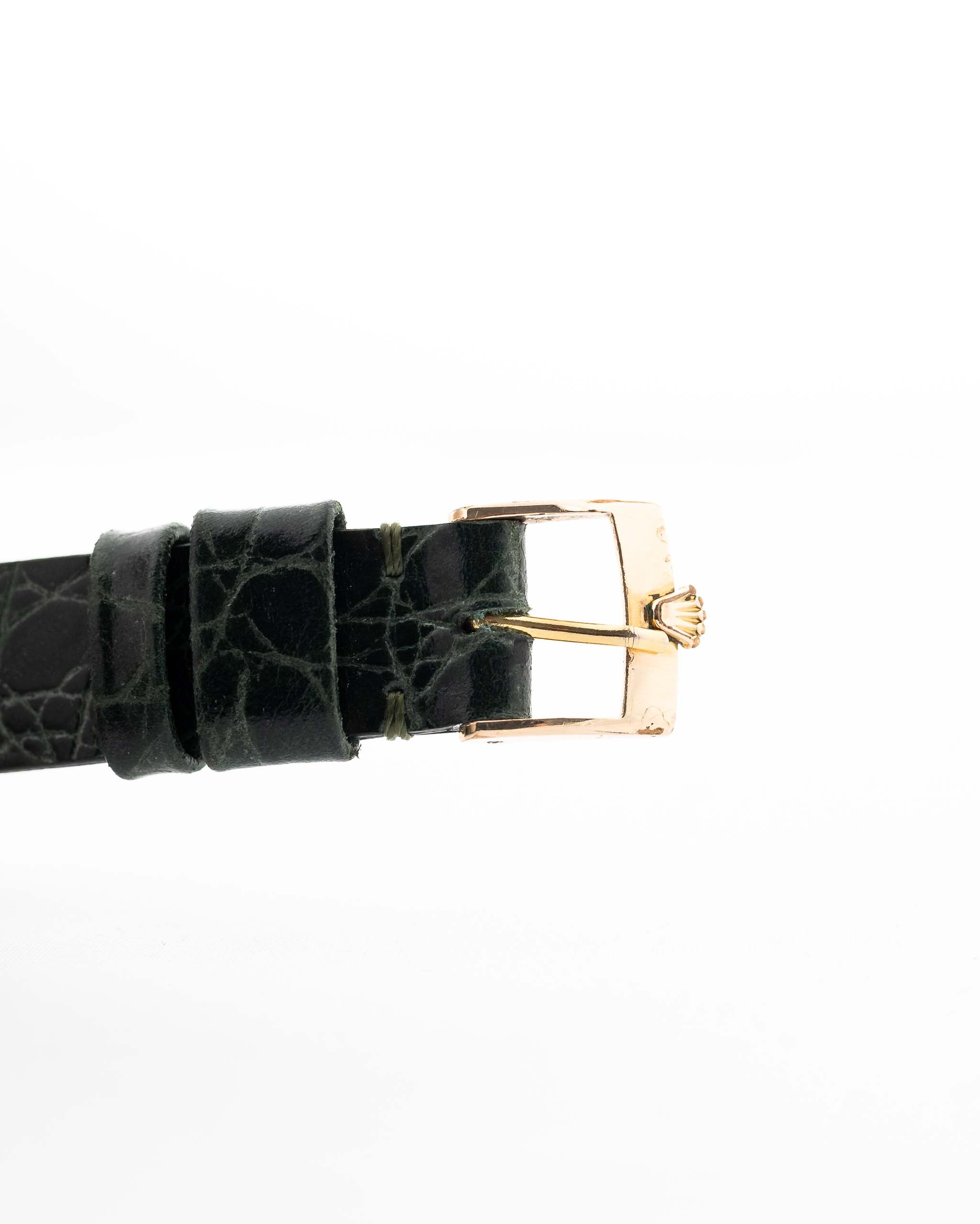 Closeup Photo of a Rolex Cellini 4105 Rectangular Black from 1976. 25.5mm  18k yellow gold case with Manual wind movement, Original black tapestry dial and Leather strap.