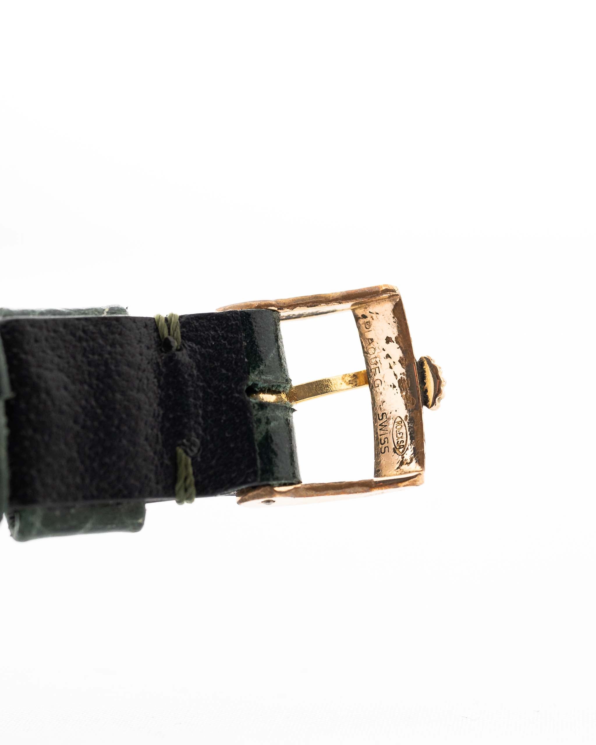 Closeup Photo of a Rolex Cellini 4105 Rectangular Black from 1976. 25.5mm  18k yellow gold case with Manual wind movement, Original black tapestry dial and Leather strap.