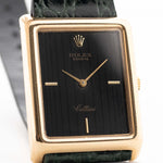 Closeup Photo of a Rolex Cellini 4105 Rectangular Black from 1976. 25.5mm  18k yellow gold case with Manual wind movement, Original black tapestry dial and Leather strap.
