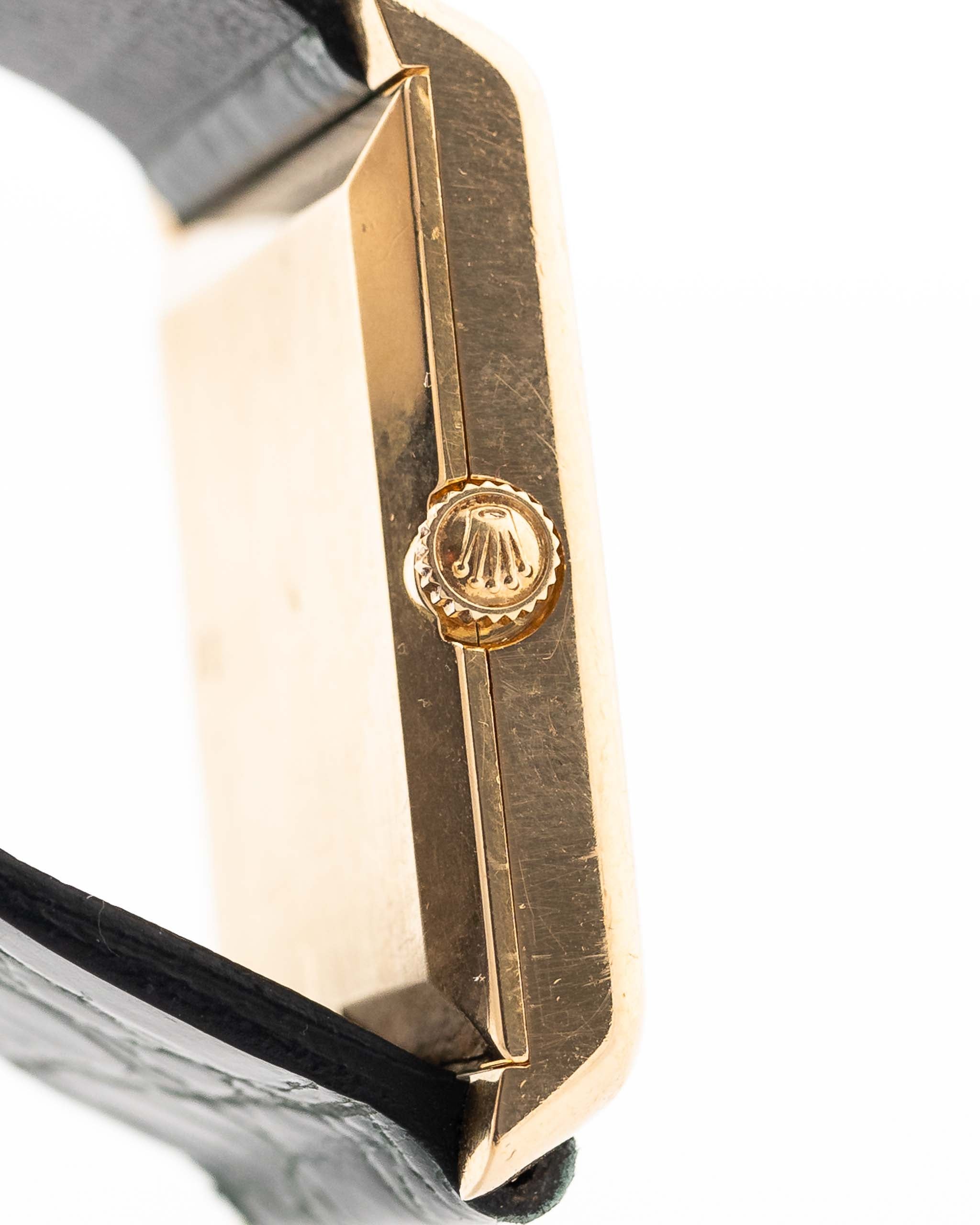 Closeup Photo of a Rolex Cellini 4105 Rectangular Black from 1976. 25.5mm  18k yellow gold case with Manual wind movement, Original black tapestry dial and Leather strap.