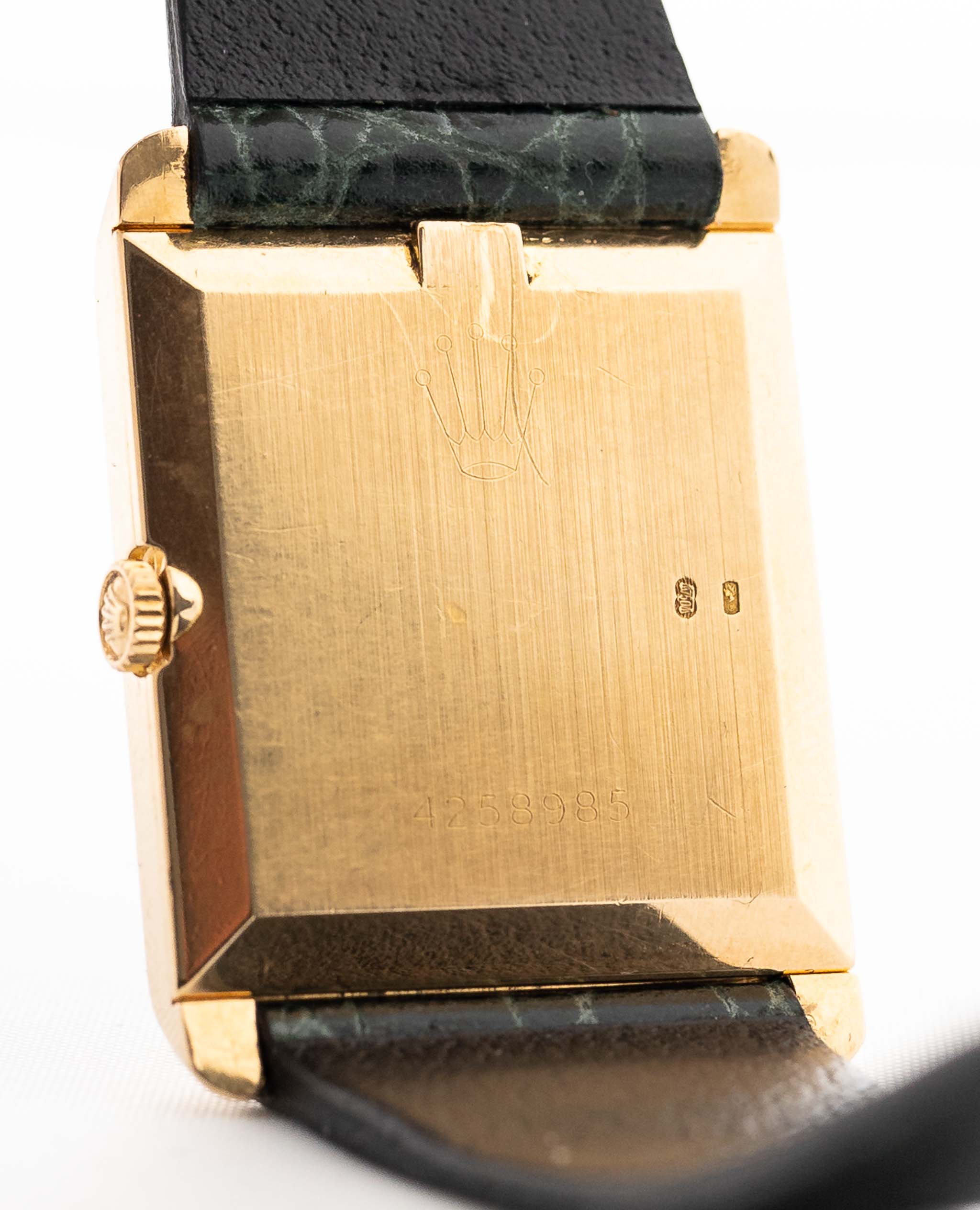 Closeup Photo of a Rolex Cellini 4105 Rectangular Black from 1976. 25.5mm  18k yellow gold case with Manual wind movement, Original black tapestry dial and Leather strap.