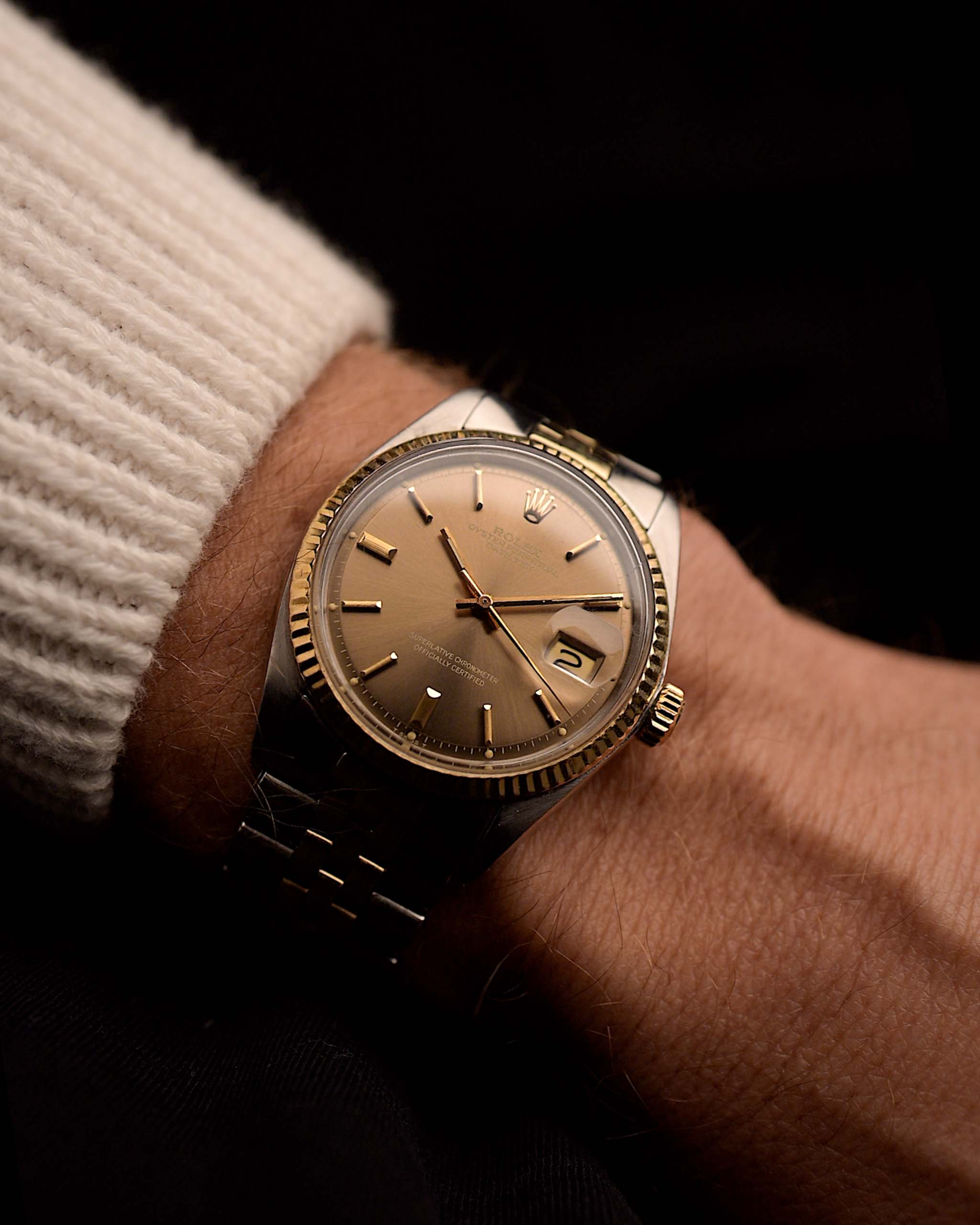 Vintage Rolex Datejust 1601 watch, brown Havana dial, stainless steel case, automatic movement, Two-tone Jubilee bracelet, on wrist, black background