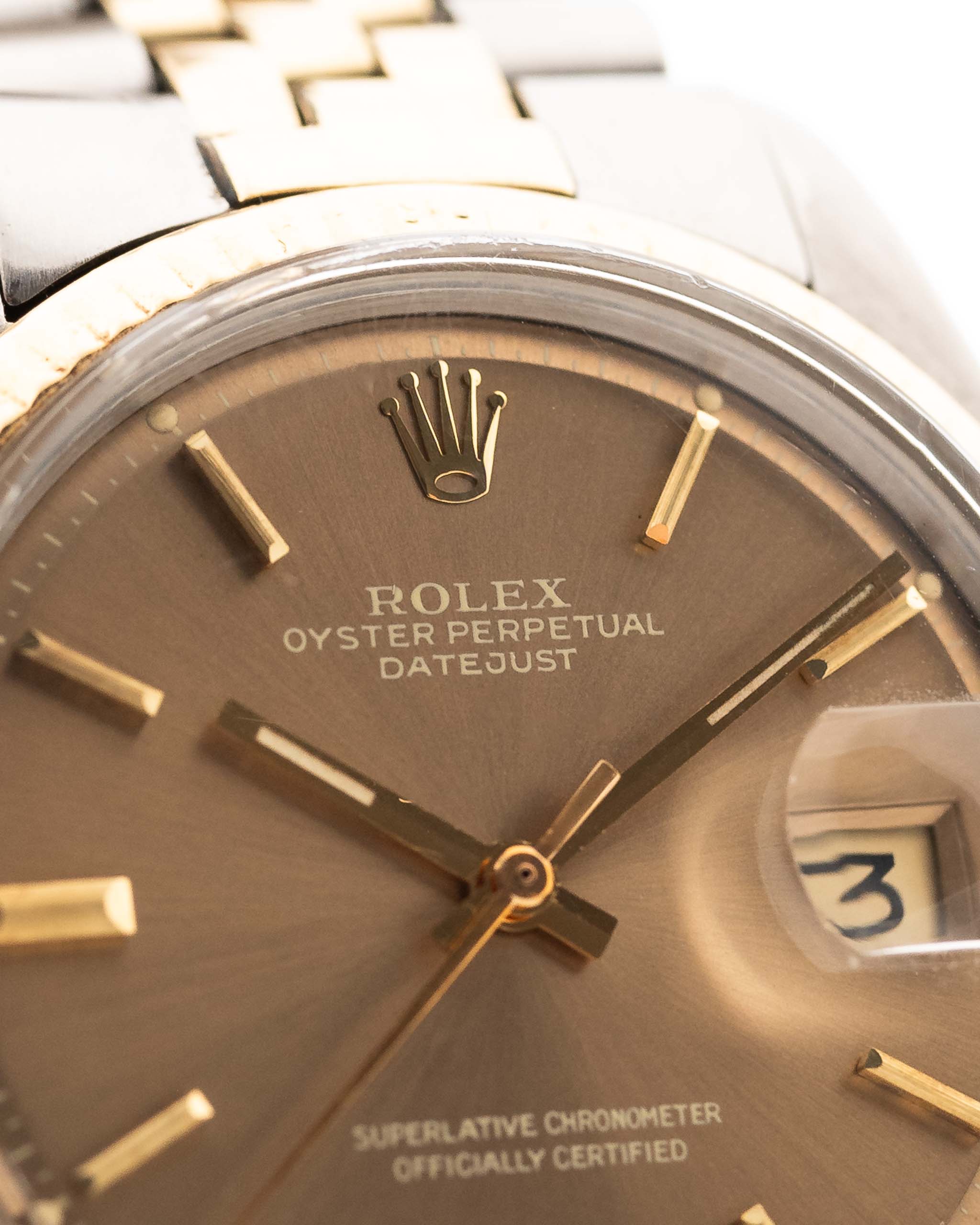 Close-up of a Vintage Rolex Datejust 1601 watch, brown Havana dial, stainless steel case, automatic movement, Two-tone Jubilee bracelet, white background