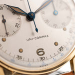 Vintage Universal Geneve 5166 Uni Compax 18k gold 1950 silver vertical brushed dial closeup