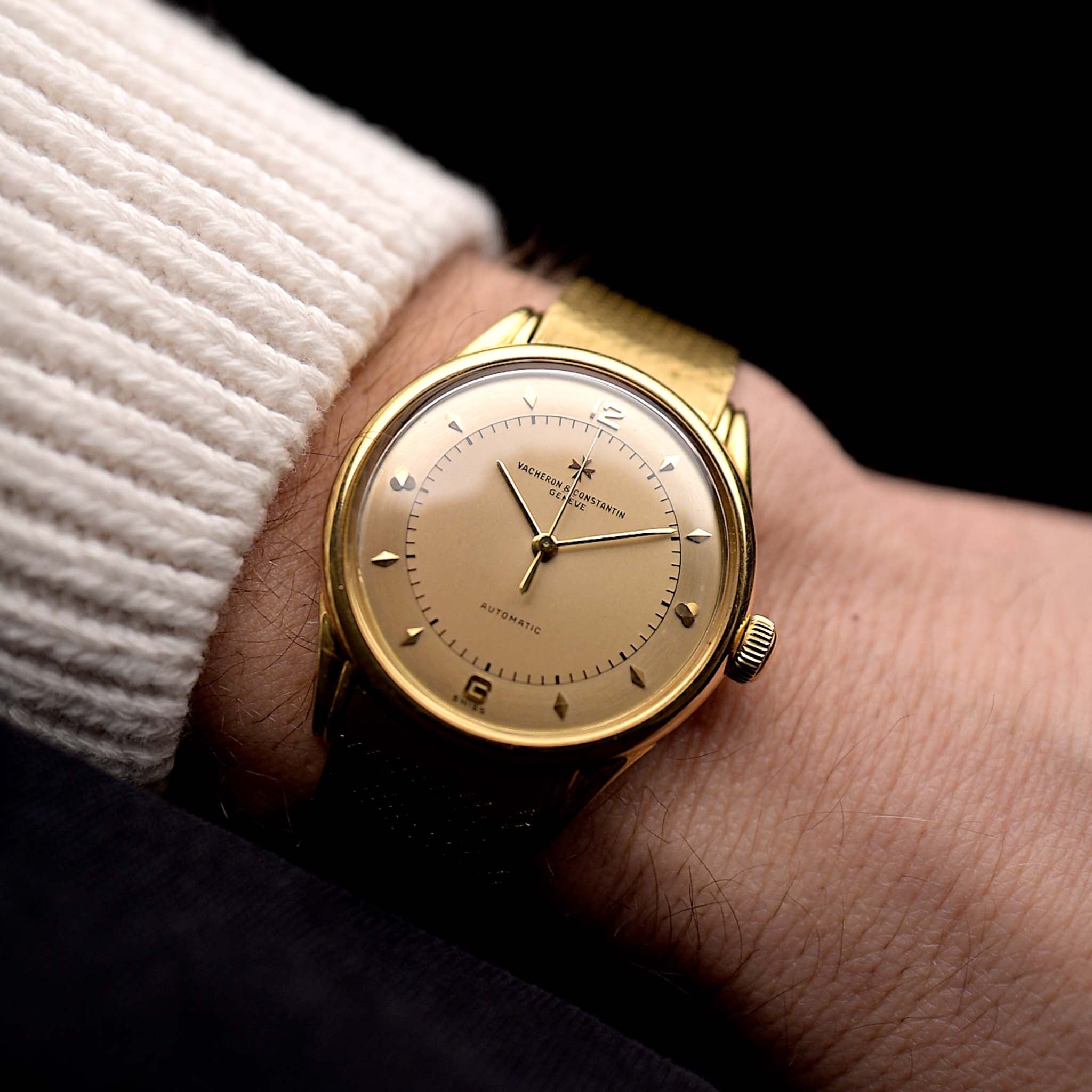 A photo of a vintage Vacheron Constantin Gold Spillman Jumbo from the 1950s on a wrist. In Yellow Gold, 36.5mm, Hammer Automatic movement with Original flawless two-tone dial and Original gold bracelet.