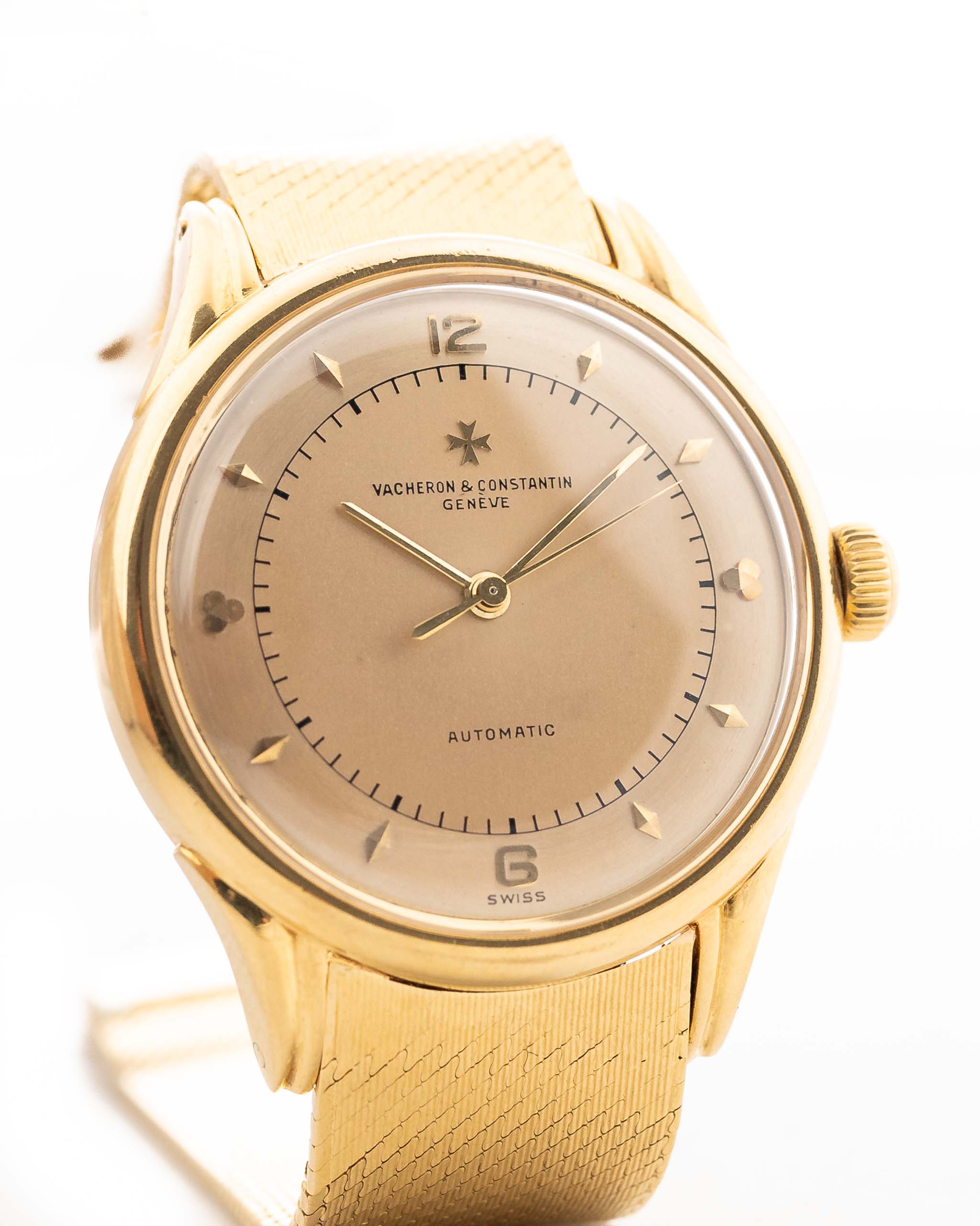 A closeup photo of a vintage Vacheron Constantin Gold Spillman Jumbo from the 1950s on a wrist. In Yellow Gold, 36.5mm, Hammer Automatic movement with Original flawless two-tone dial and Original gold bracelet.