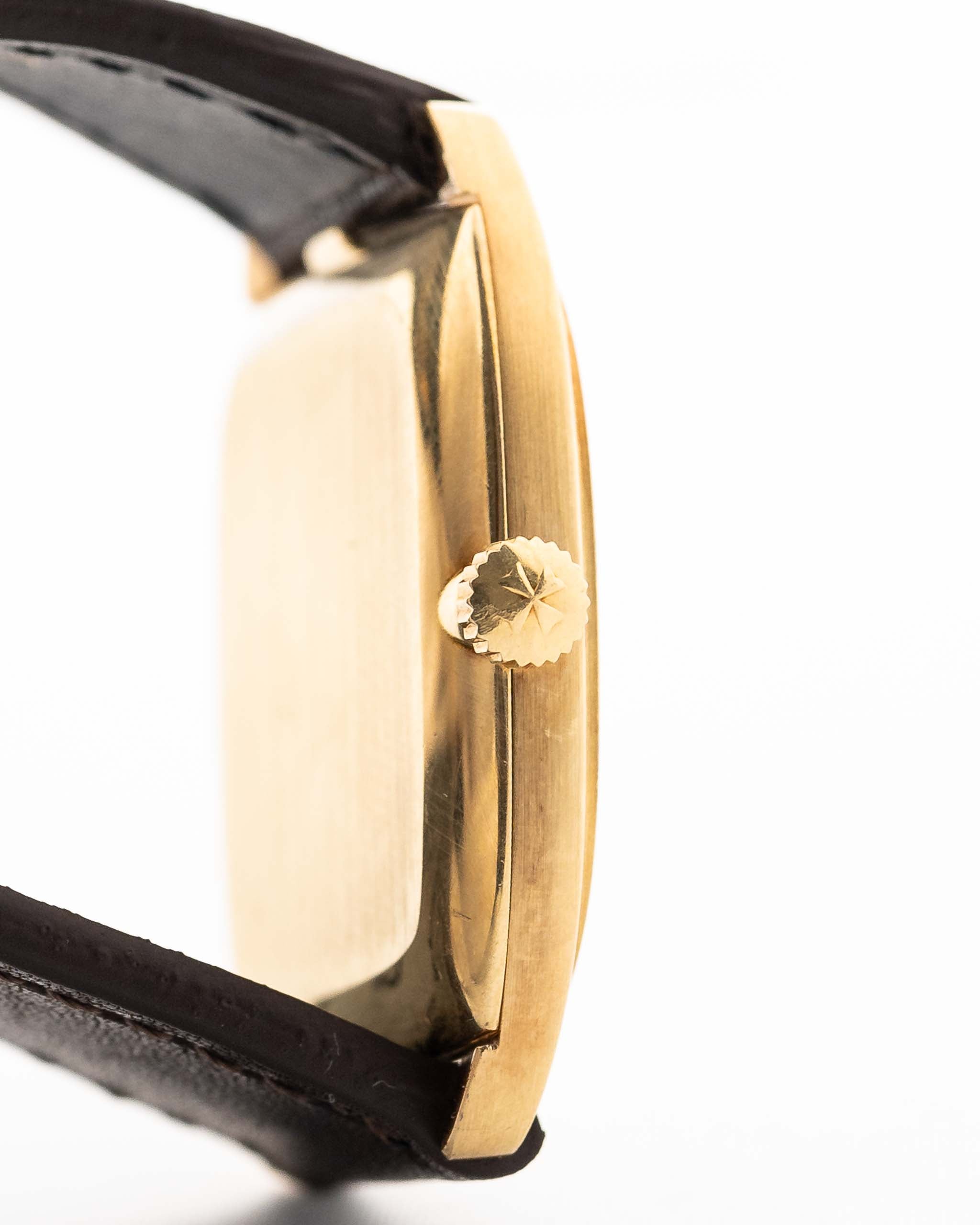 Closeup Photo of a Vacheron Constantin 39014 Tonneau 18k from the 1980s. 27mm 18k yellow gold case with Manual wind movement, Original Sigma dial and Leather strap.