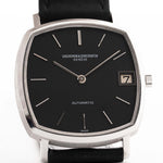 Vacheron Constantin watch with black face and leather strap on a white background
