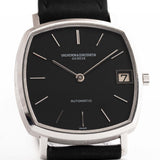 Vacheron Constantin watch with black face and leather strap on a white background