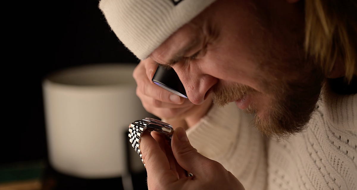 A man inspecting a watch