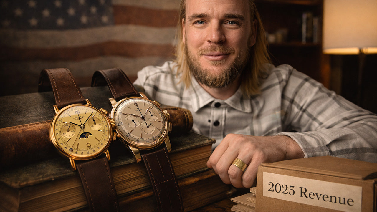 Man with a beard holding a box labeled '2025 Revenue' next to two vintage watches on books.