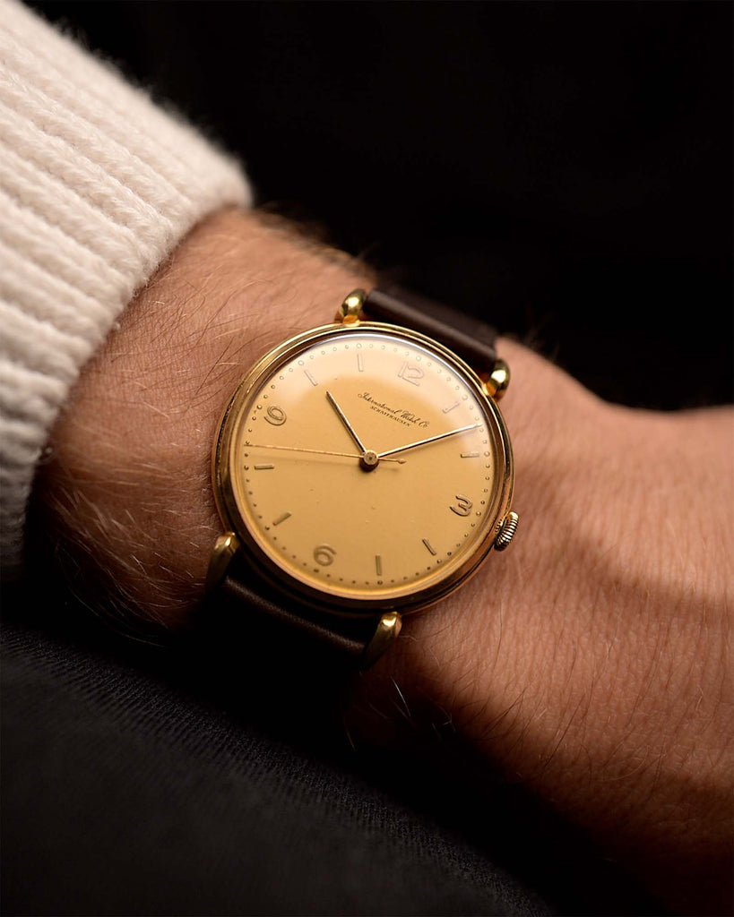 Vintage Omega Medicus Watch Salmon Roman from 1944 on a wrist. 28mm, Stainless Steel, Manual wind Caliber 23.4 SC with Flawless salmon dial, Roman numerals and Black leather strap.