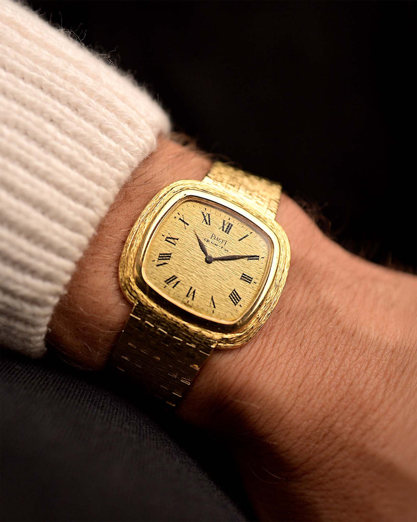Vintage Piaget Square Watch 75121 Roman Bark from the 1970s on a wrist. 34mm in 18k Yellow Gold with Quartz movement, Flawless Gold dial and Integrated bracelet.