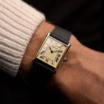 Vintage Cartier Tank Louis 78086 Paris from the 1970s on a wrist. 23x30mm with 18k Yellow Gold Case, Manual Wind Movement, Flawless Ivory Dial, Hands and Leather Strap.