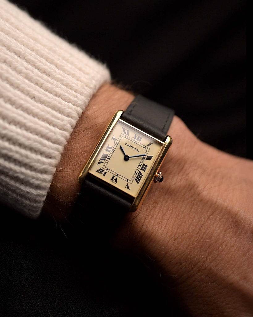 Vintage Cartier Tank Louis 78086 Paris from the 1970s on a wrist. 23x30mm with 18k Yellow Gold Case, Manual Wind Movement, Flawless Ivory Dial, Hands and Leather Strap.