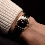 Video of a Piaget Tonneau 9691 Onyx 18k from the 1970s on a wrist. 24mm with 18k Yellow Gold Case, Manual Wind Movement, Black Onyx Dial and Original black Leather Strap.