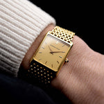Video of a Audemars Piguet 18k Tank from the 1980s on a wrist. 25mm case in 18k Yellow Gold with Manual wind movement, Original golden dial, Hands with sapphire cabochon and Beads of rice bracelet.