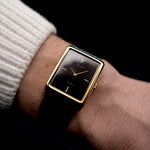 Video of a Rolex Cellini 4105 Rectangular Black from 1976 on a wrist. 25.5mm  18k yellow gold case with Manual wind movement, Original black tapestry dial and Leather strap.