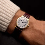 Vintage Cartier Arcade Paris Watch 9605 Two Tone from the 1980s on a wrist. 24mm with 18k Yellow Gold Case, White Gold Bezel, White Paris Dial, Manual Wind Movement and Leather Strap.