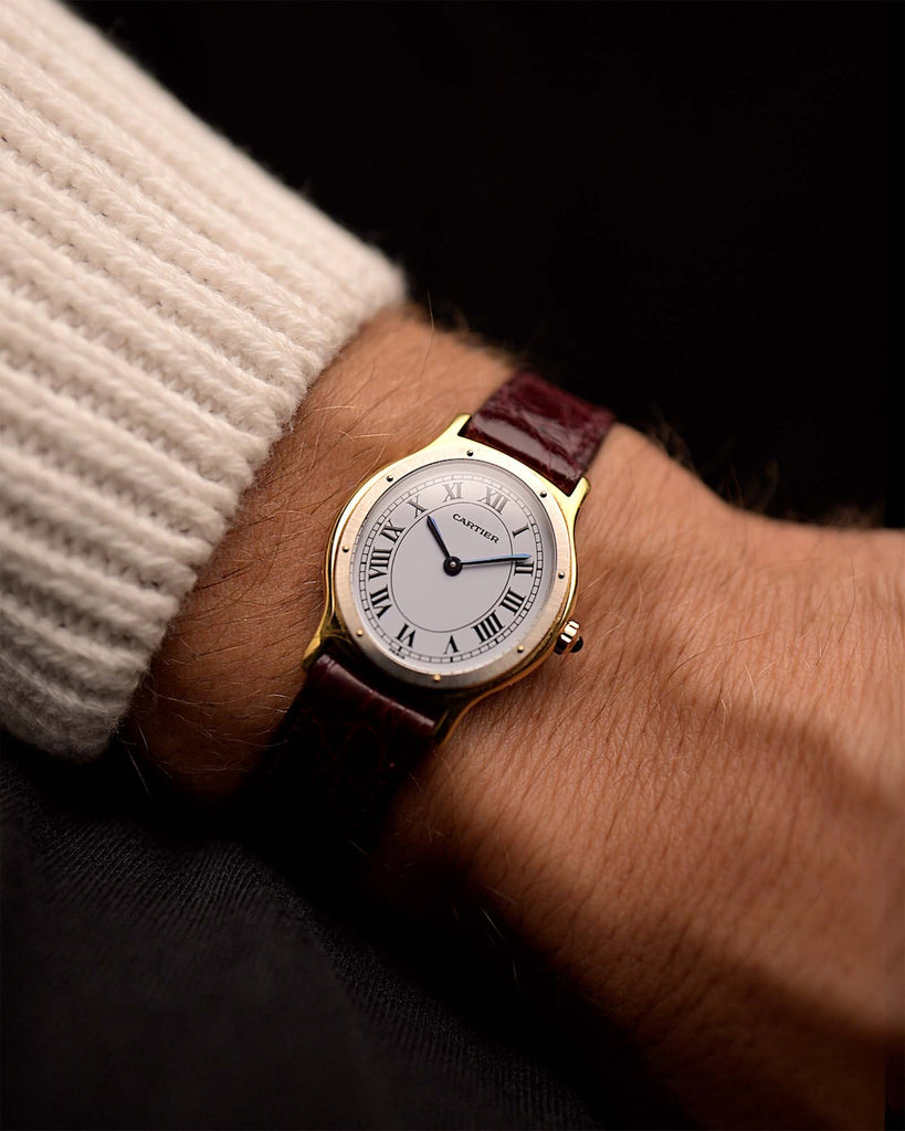 Vintage Cartier Arcade Paris Watch 9605 Two Tone from the 1980s on a wrist. 24mm with 18k Yellow Gold Case, White Gold Bezel, White Paris Dial, Manual Wind Movement and Leather Strap.