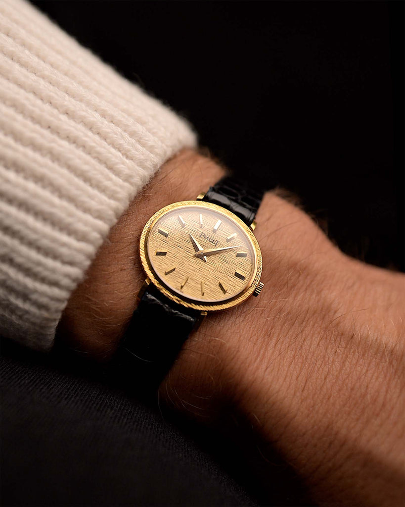 Vintage Piaget Ellipse Watch 9801 Bark 18k from the 1970s on a wrist. 27mm with 18k Yellow Gold Case, Flawless Bark-Finished Dial, Manual Wind Movement and Leather Strap.