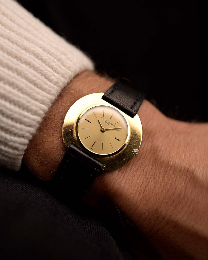 Vintage Vacheron Constantin Disco Volante 6590 watch from 1960s on a wrist. 34mm in 18k Yellow Gold with Flawless Gold sunburst dial, Manual wind movement and Leather Strap.