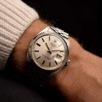 Vintage Rolex Datejust 1601 Silver Pie Pan Watch from 1973 on a wrist. 36mm in Stainless Steel with Automatic Caliber 1570, Silver Pie Pan Dial, Jubilee bracelet in Excellent condition.