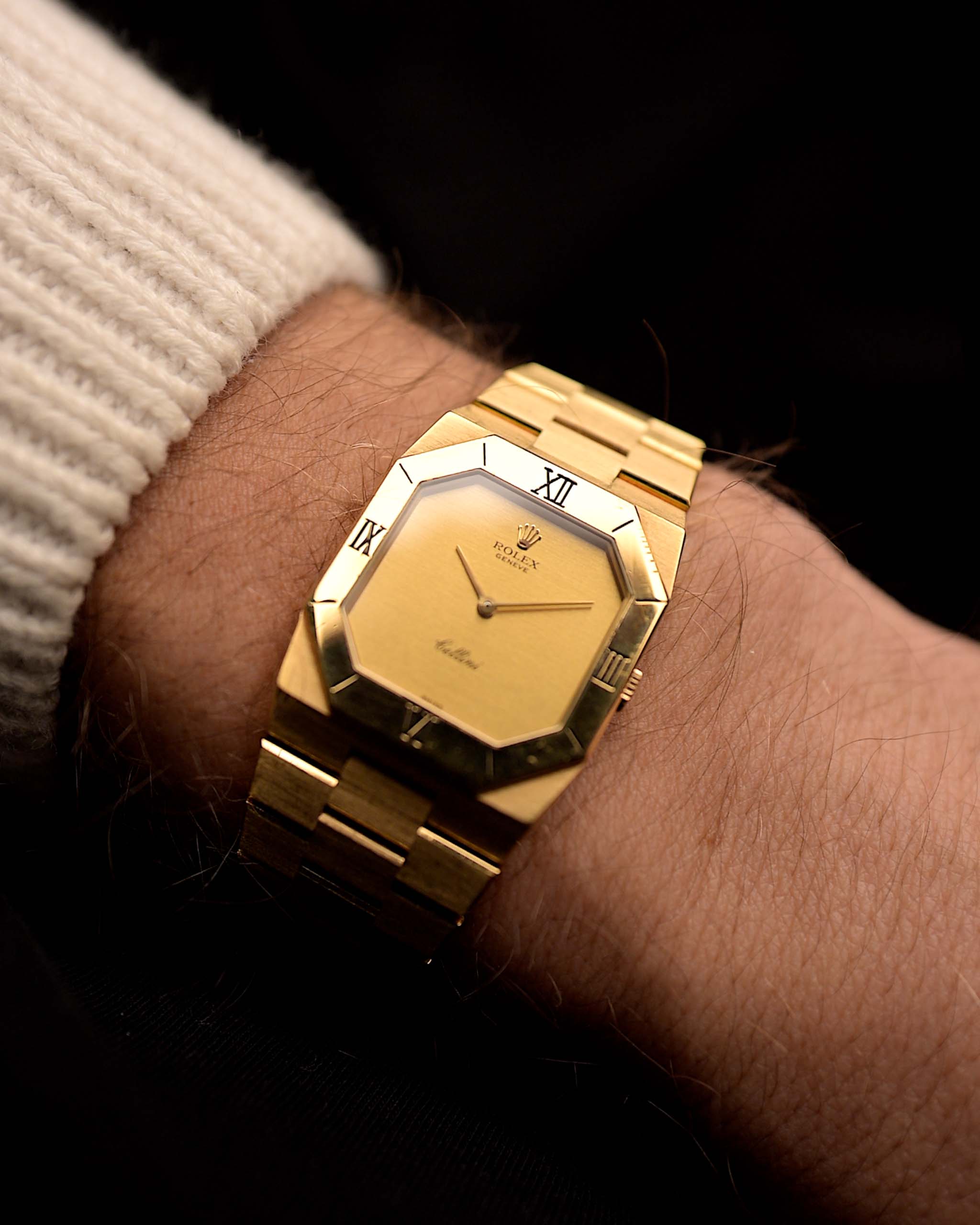 Vintage Rolex Cellini 4350 watch in 18k yellow gold, octagonal case, golden brushed dial, manual movement, on wrist, black background, video