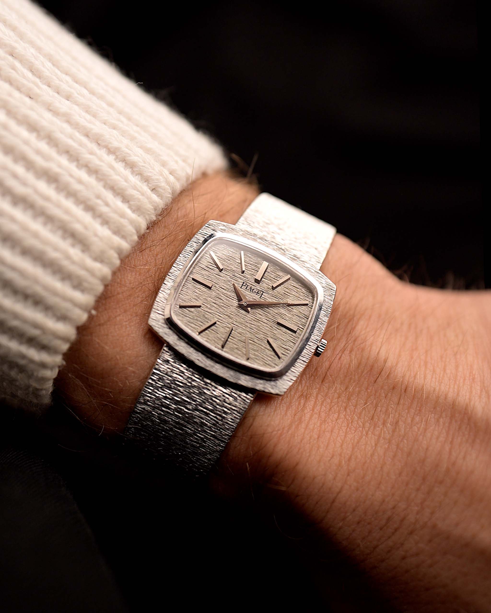 Vintage Piaget TV 9574 watch 18k white gold bark TV case, white gold dial, manual wind, integrated bracelet on a wrist on black background, video.