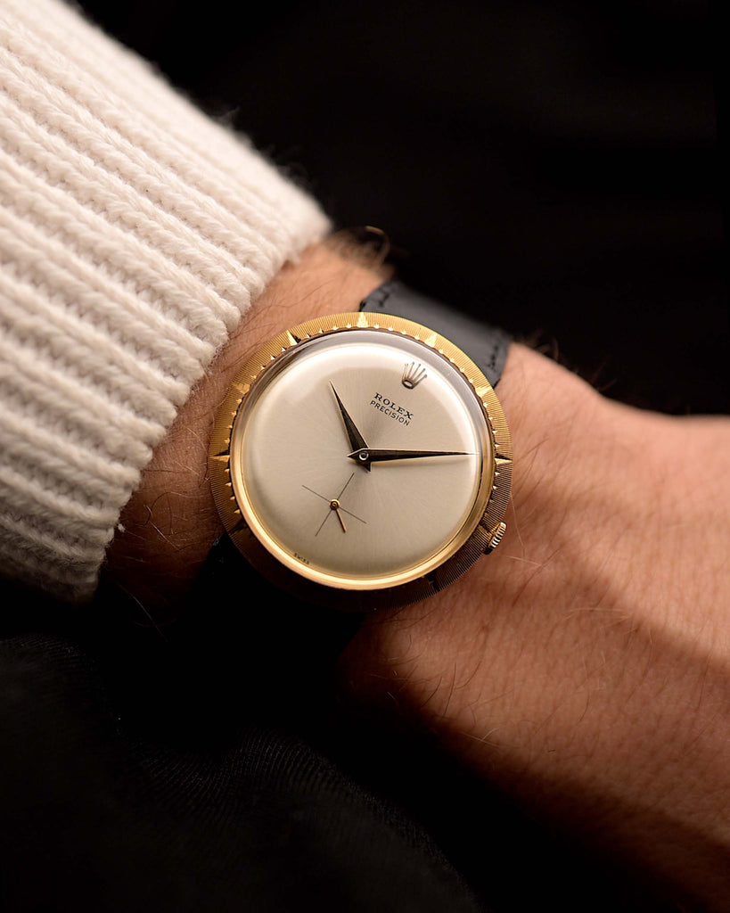 Vintage Rolex Zephyr 9522 watch, in 18k gold disco volante case, silver dial, manual wind, black strap on a wrist on black background, video