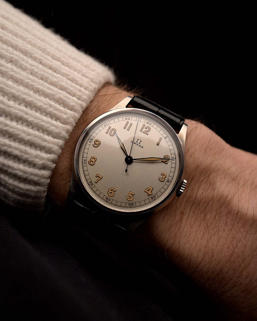 Vintage Omega Jumbo Railroad sword watch from 1939 featuring a stainless steel case, silver Railroad dial, manual movement on a wrist on black background, video