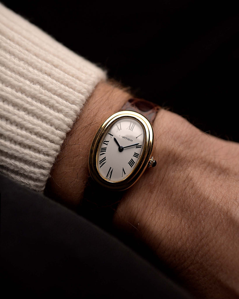 Vintage Cartier Baignoire 78094 Paris from the 1980s on a wrist. 22mm ·with 18k Yellow Gold Case, Manual movement, Original white Paris dial and Leather strap.