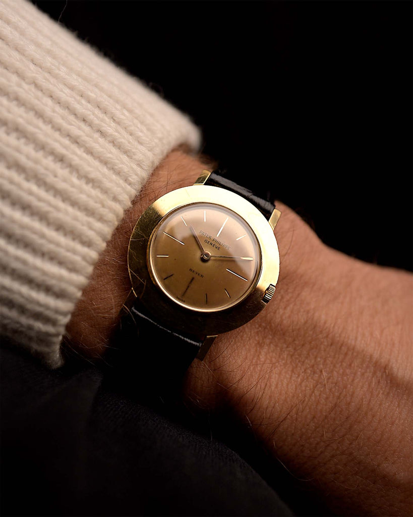 Vintage Patek Philippe 2594 Disco Volante Beyer 1950s on a wrist. 32mm wide with 18k Yellow Gold Case, Manual Caliber 23-300, Cappuccino Dial and Black Leather Strap.