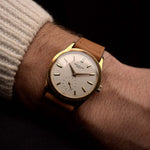 Vintage Patek Philippe 3796 watch from the 1980s, 31mm 18k yellow gold case, silver sigma dial, manual wind movement, on a wrist on black background, video