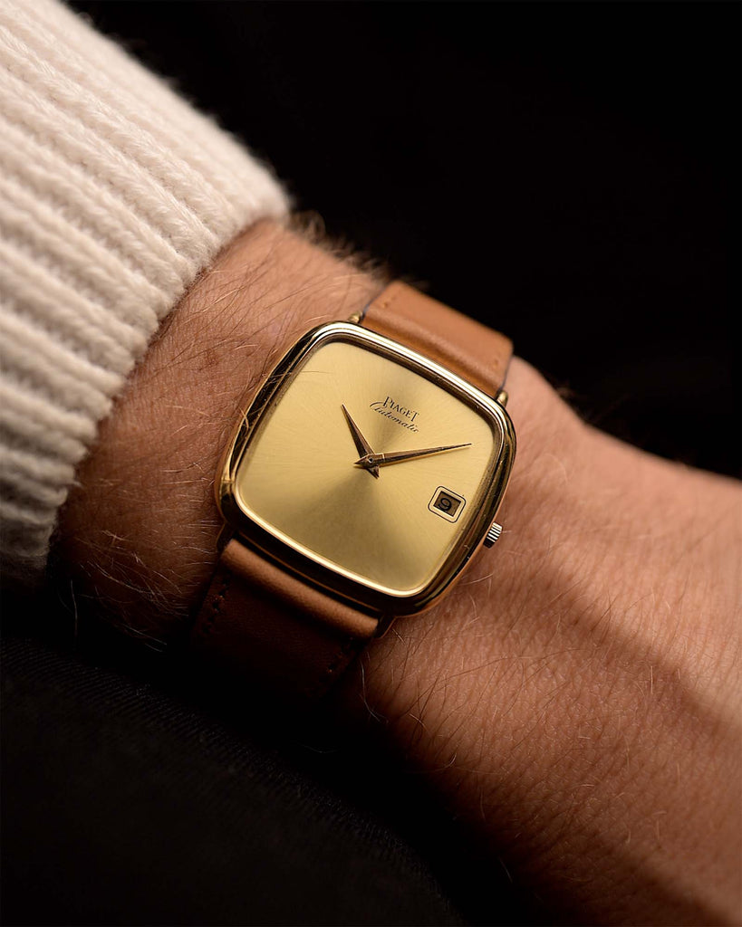 Vintage Piaget TV Watch 13773 Automatic Date 18k from the 1970s on a wrist. 31.5mm with 18k Yellow Gold Case, Automatic Caliber 12P1, Flawless Golden Dial and Original Leather Strap.