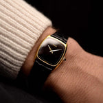 Vintage Piaget Tonneau 9691 Watch Onyx 18k from the 1970s on a wrist. 24mm in 18k Yellow Gold with Manual Wind Movement, Flawless Black Onyx Dial and Black Leather Strap.