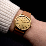 A video of a vintage Rolex Cellini 3806 Ellipse 18k from 1974 on a wrist in Yellow gold. 32mm, Manual wind movement, Original golden dial and Original hands & crown with cognac brown Leather strap.