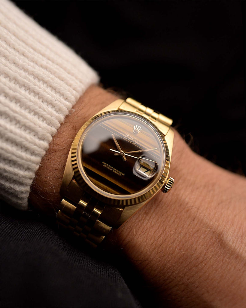 Vintage Rolex Datejust 1601 Watch Tiger Eye from 1975 on a wrist. 36mm in 18K Yellow Gold with Automatic Caliber 1570, Original Tiger Eye Dial and Original Jubilee Bracelet.