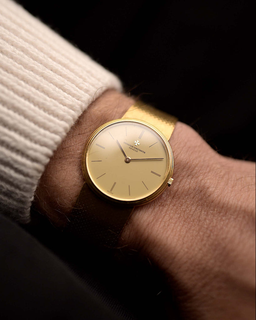 Vintage Vacheron Constantin 33216 Patrimony watch from the 1980s on a wrist. 31mm wide in 18k Yellow Gold with Flawless Cream Dial, Manual Wind VC Caliber 1003 and 18k Gold Bracelet.