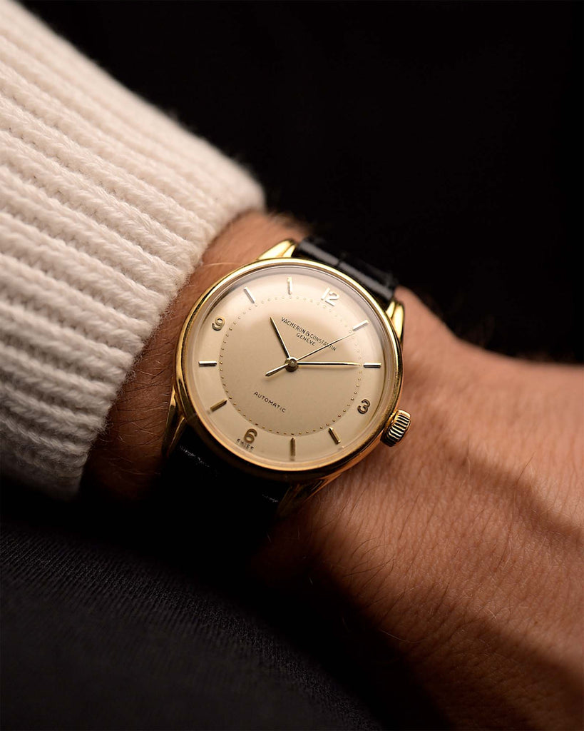Vintage Vacheron Constantin Patrimony Spillmann Watch from the 1940s on a wrist. 34.5mm with 18k Yellow Gold case, Champagne two-tone dial, Automatic movement and Leather strap.