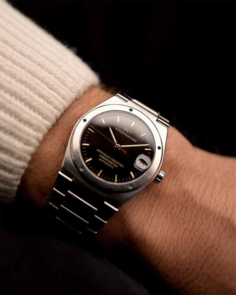 Vintage IWC Ingenieur 3521 watch from the 1990s on a wrist on black background.