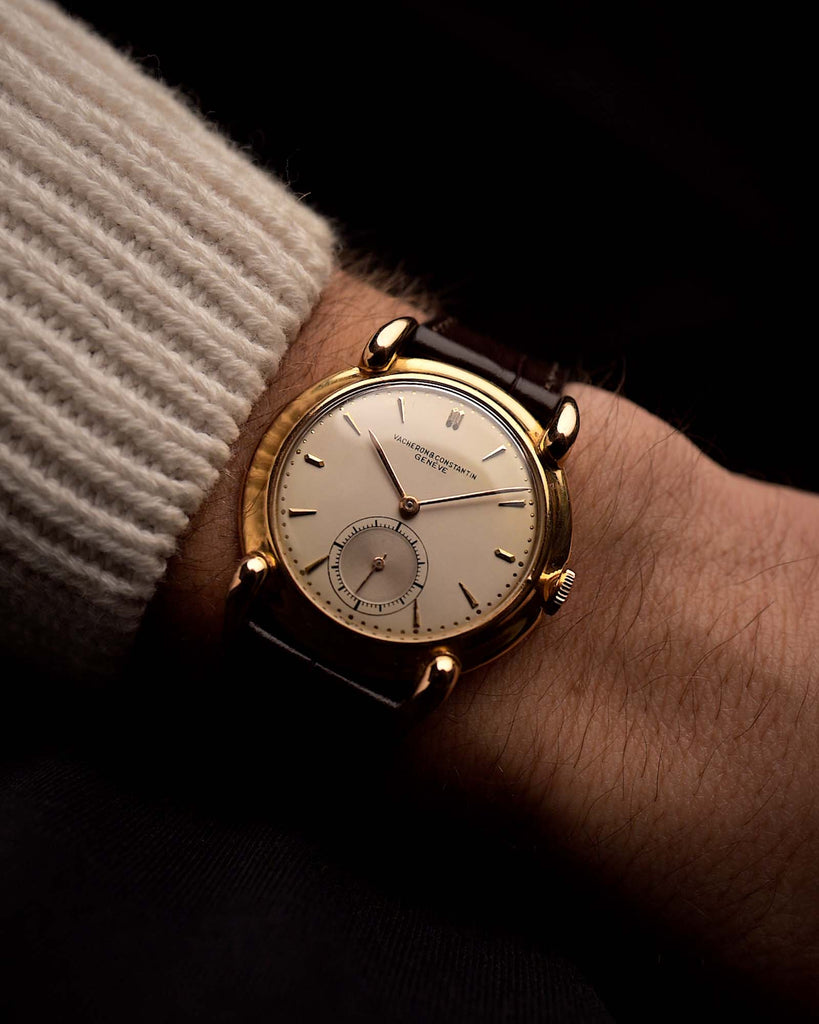 Vintage Vacheron Constantin Jumbo Teardrop Uhr, 18 Karat Roségold, champagnerfarbenes Zifferblatt, Cal. 453, braunes Lederarmband, an einem Handgelenk vor schwarzem Hintergrund, Video
