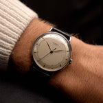 Vintage Universal Geneve 20706 Cal. 263 Major Twelve from 1945 on a wrist. 35mm with Stainless Steel Case, Manual Cal. 263 movement, Silvered dial, Leaf hands and Black Leather strap.