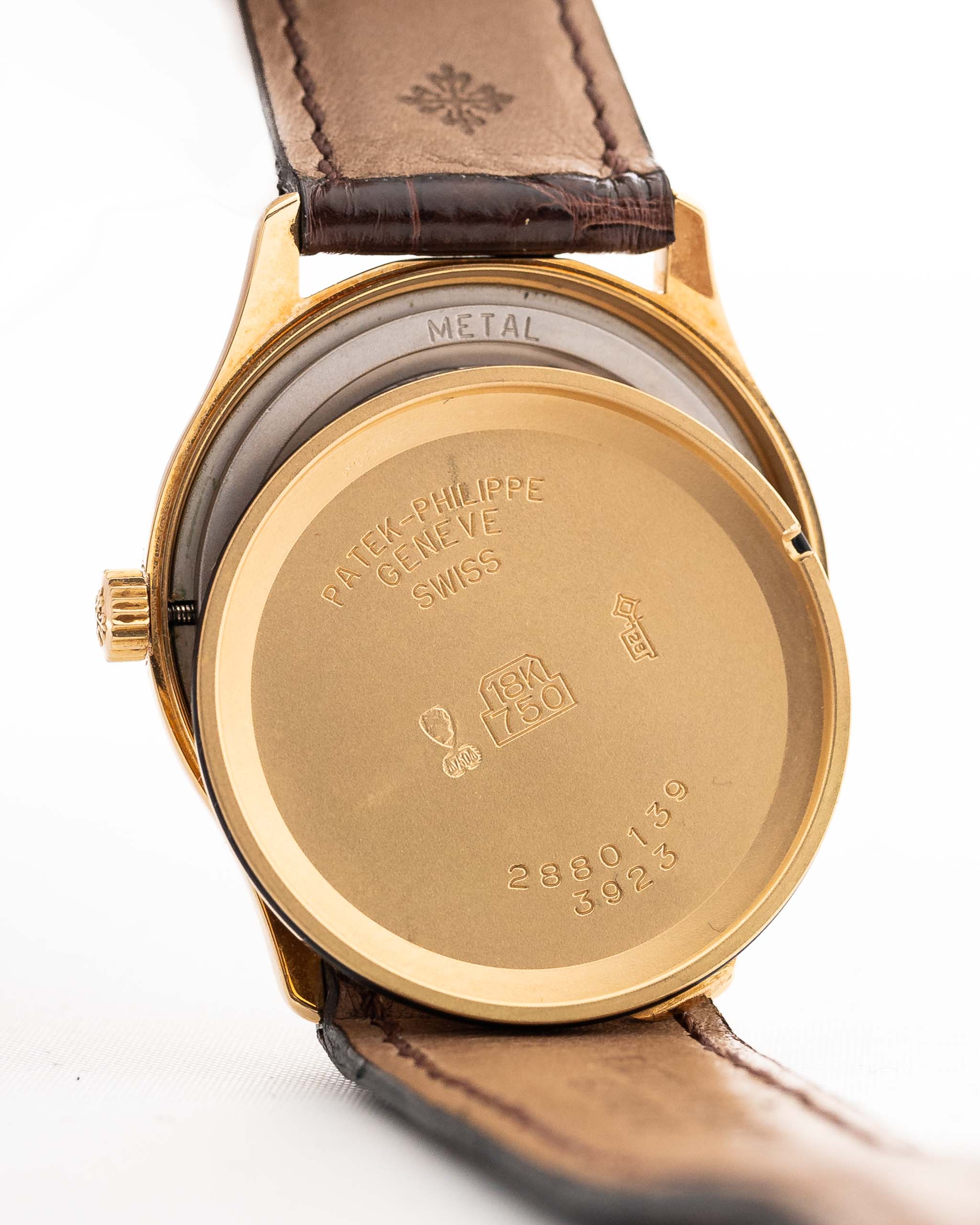 Primo piano di una cassa vintage Patek Philippe 3923 Calatrava degli anni Novanta. 32 mm in oro giallo 18 carati con movimento a carica manuale, quadrante Sigma, cinturino in pelle originale e fibbia in oro 18 carati.
