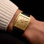 Foto di un Vacheron Constantin 7374 Tonneau del 1973 al polso. 28 mm in oro giallo 18 carati con movimento a carica manuale, quadrante dorato spazzolato e cinturino in pelle originale.
